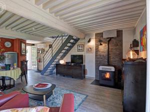 a living room with a fireplace and a staircase at Gîte au cœur d'un village médiéval, charme et confort moderne - FR-1-496-125 in Chagnon