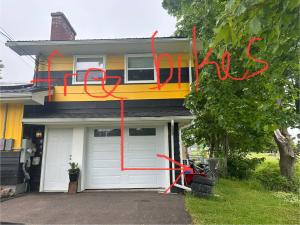 a house with red writing on the side of it at Cozy Small Room - Queen bed - Free Parking in Charlottetown in Charlottetown