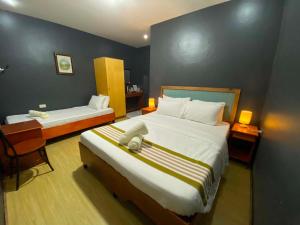 a hotel room with two beds and a desk at Angkel's Place in Bangued +82 photos