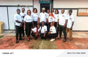 a group of people posing for a picture in front of a building at Hôtels Bali in Yaoundé