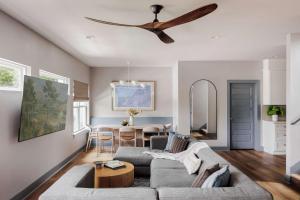 a living room with a couch and a ceiling fan at Modern Designer Home with Shared Pool in Austin