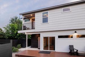 a white house with a balcony and a deck at Modern Designer Home with Shared Pool in Austin