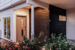 a black and white house with a front door at Modern Designer Home with Shared Pool in Austin +26 photos