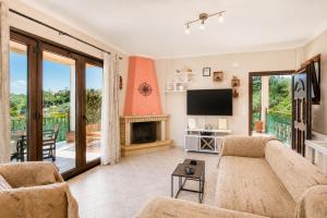 a living room with a couch and a fireplace at Villa Elpida in Gaios