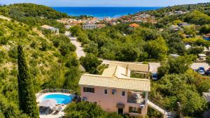 a house on a hill with a swimming pool at Villa Elpida in Gaios