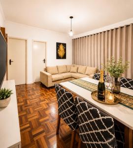 a living room with a table and a couch at Roupa cama Wi-Fi garagem ar Cond beira mar 50 m in Tramandaí