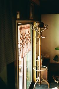 a lamp next to a glass door with a window at ましこのま- 明治の建物をリノベした街中ローカルステイ in Mashiko
