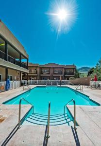 a large swimming pool in front of a building at Luxury Condo 2Bed, 1Bath, Pool, Hot Tub, Beach, Golf in Osoyoos