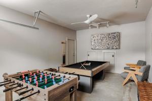 a ping pong table in a room with a pool table at Expansive Luxury Escape with Private Pool in Austin