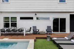 a patio with a table and chairs and a pool at Expansive Luxury Escape with Private Pool in Austin +32 photos