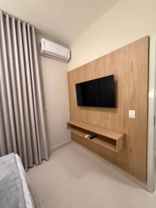 a room with a tv on a wall at Apto Mais Decor 02 in Salinas