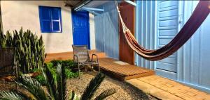 a porch with a hammock on a house at Pousada Vino & Leta O seu parador no centro in Grão Pará +53 photos