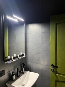 a bathroom with a sink and a mirror at Malina Utsera in Oni