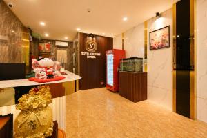 a lobby with a room with a fish tank in it at Yoyo Airport Saigon Hotel in Ho Chi Minh City