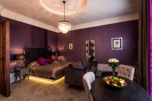 a bedroom with a bed and a table with a bowl of fruit at Midlands Park Hotel in Portlaoise