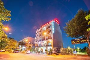 a building with a neon sign on top of it at Winston Hotel Riverside in Ho Chi Minh City +21 photos