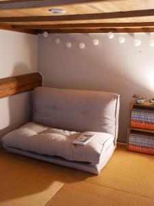 a bed in the corner of a room at ましこのま- 明治の建物をリノベした街中ローカルステイ in Mashiko