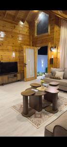 a living room with a couch and a table at اكواخ اليمامة in Al Baha
