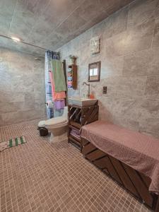 a bathroom with two beds and a sink and a toilet at SiempreViva Hospedaje By GEstores in Chignahuapan +82 photos