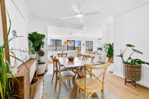 a dining room with a table and chairs at Pacific Place Apartments in Gold Coast