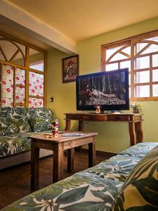 a living room with a tv and a table at SiempreViva Hospedaje By GEstores in Chignahuapan