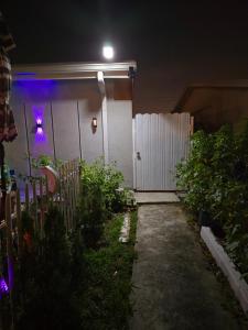 a house with a gate at night with a purple light at Healing Minds Home in Miramar