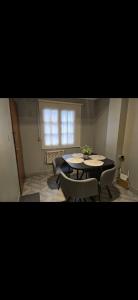a room with a table and chairs and a window at Danella in San Miguel de Tucumán