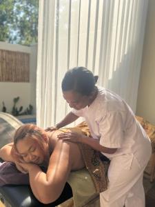 a man helping a woman on a bed at Villa Sea La Vie Private pool in Gili Meno