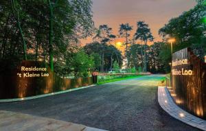 a road in a park with the sunset in the background at Tiny House 10 Met Hottub in Wenum