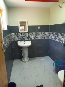 a bathroom with a sink and a mirror at Stone Leaf Retreat - Skardu in Skardu