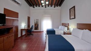 a hotel room with two beds and a television at Holiday Inn Express Veracruz Centro Historico by IHG in Veracruz +65 photos