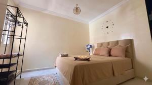 a bedroom with a bed with a table on it at Cozy Apartment Near Rabat & Beach in Temara