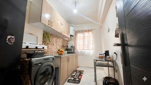 a kitchen with a washer and dryer in it at Cozy Apartment Near Rabat & Beach in Temara