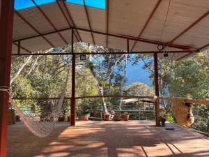 a hammock in a pavilion with a view of a mountain at Etrita Inkas Hostel in Sahuayacu