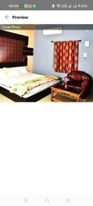 a room with two beds and a couch in it at Hotel Royal Palace Dharamgarh in Dharamgarh