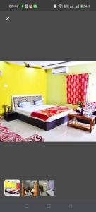 a bedroom with a bed and a yellow wall at Hotel Royal Palace Dharamgarh in Dharamgarh