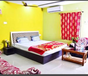 a bedroom with a bed and a yellow wall at Hotel Royal Palace Dharamgarh in Dharamgarh