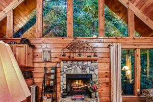 a living room with a fireplace in a log cabin at Mountain Joy cabin in Gatlinburg