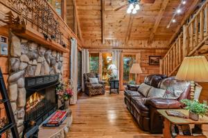 a living room with a fireplace in a log cabin at Mountain Joy cabin in Gatlinburg