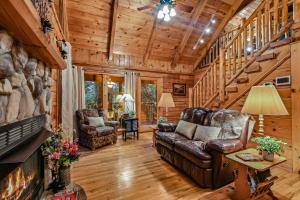 a living room with a couch and a fireplace at Mountain Joy cabin in Gatlinburg