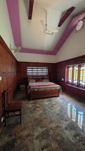 a bedroom with a bed in a room with purple ceilings at Coffeehut Pool Villa in Pinangode