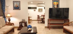 a living room with a large flat screen tv at Casa Niño Peregrino Salinas in Salinas