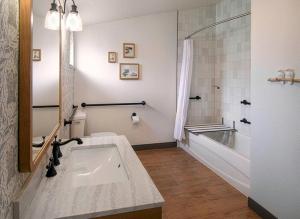 a bathroom with a sink and a tub and a toilet at Fireside Inn on Moonstone Beach in Cambria +37 photos