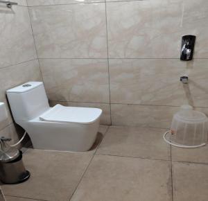 a bathroom with a white toilet and a shower at Annai Ocean Park in Velankanni +16 photos