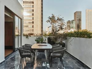 a patio with a table and chairs on a balcony at Kimpton El Castelar Polanco by IHG in Mexico City