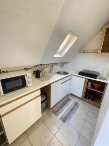 a small kitchen with a sink and a microwave at Pärlan 1 in Balatonboglár