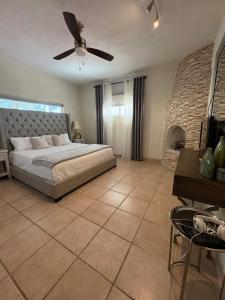 a bedroom with a bed and a ceiling fan at Almost heaven beach house in Puerto Peñasco