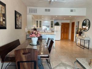 a kitchen and dining room with a table with flowers on it at Almost heaven beach house in Puerto Peñasco