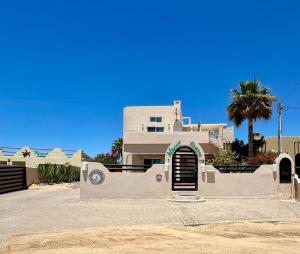 a white house with a door in front of it at Almost heaven beach house in Puerto Peñasco