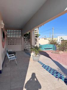 a shadow of a person standing on a patio at Almost heaven beach house in Puerto Peñasco